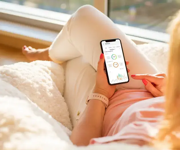 Woman checking her energy usage on her phone app after having domestic Solar Panels installed in Ireland.